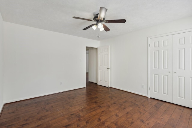 unfurnished bedroom featuring a textured ceiling, a closet, ceiling fan, and dark wood-type flooring