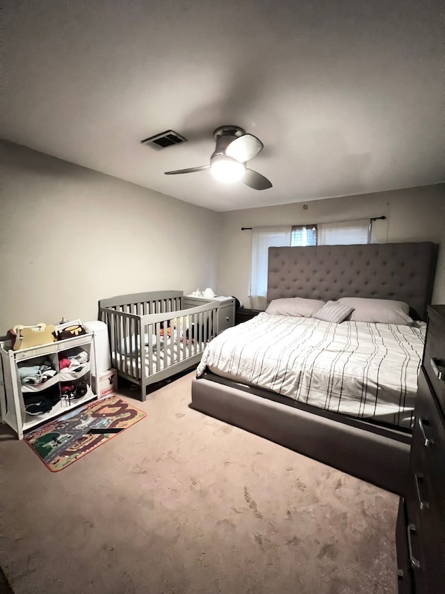 bedroom featuring light carpet and ceiling fan