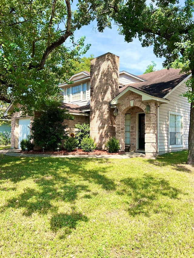 view of front of property featuring a garage and a front yard