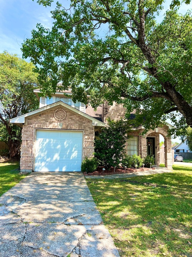 view of front of home with a front yard and a garage