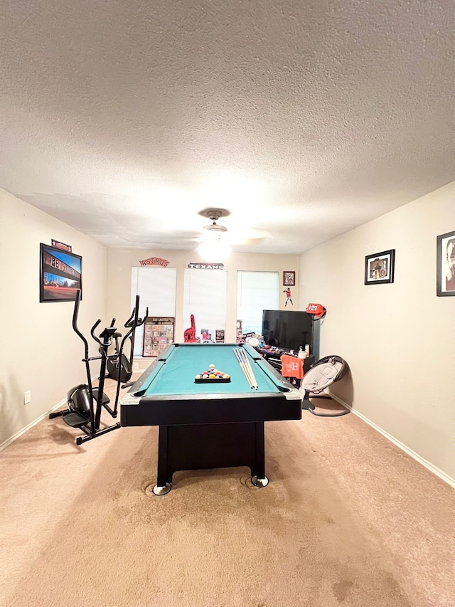 game room with a textured ceiling, billiards, and carpet