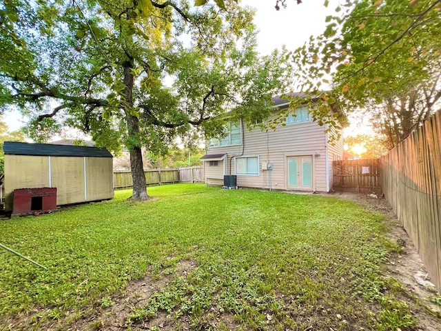 view of yard featuring central AC unit and a storage unit