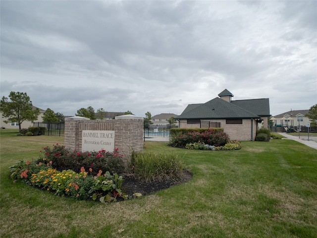 community / neighborhood sign with a yard