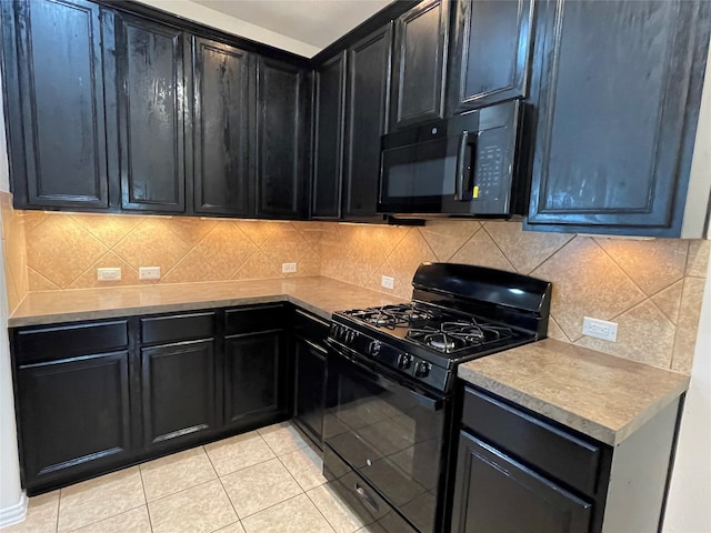 kitchen with backsplash, light tile patterned floors, and black appliances