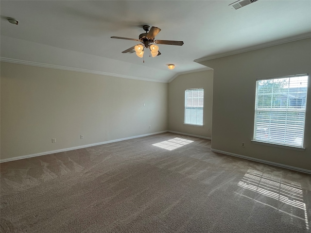 empty room featuring a healthy amount of sunlight, carpet flooring, vaulted ceiling, and ceiling fan