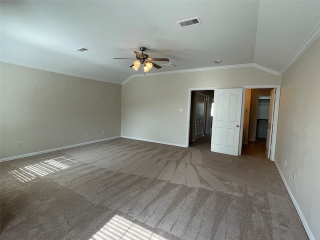 carpeted spare room with ornamental molding, lofted ceiling, and ceiling fan