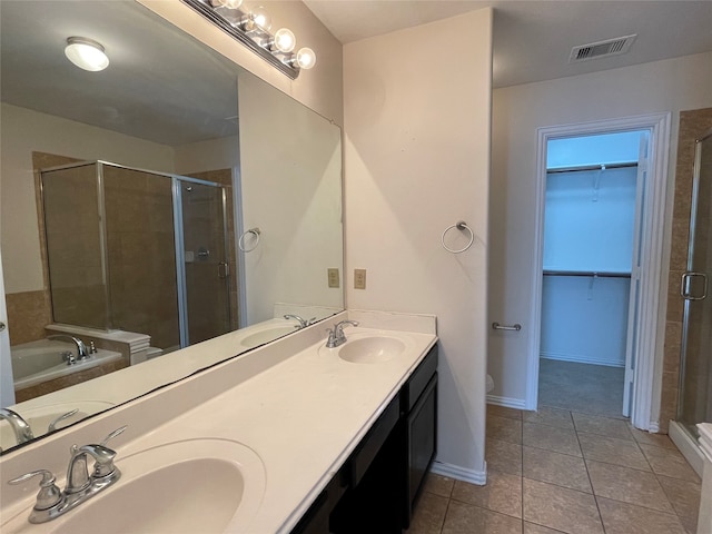 bathroom with shower with separate bathtub, tile patterned floors, and vanity