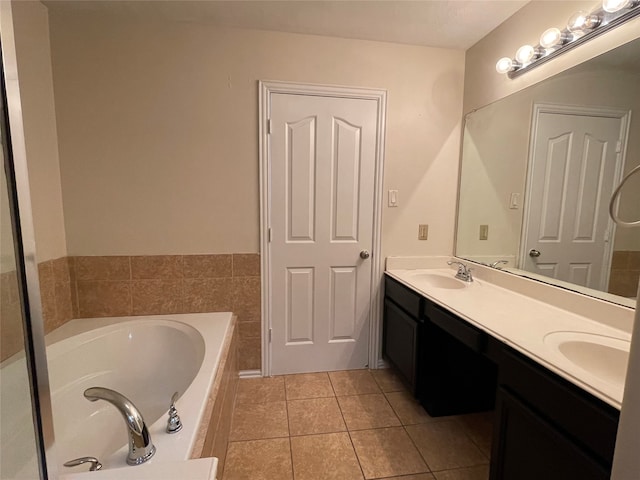 bathroom featuring vanity, tile patterned floors, and a bathing tub