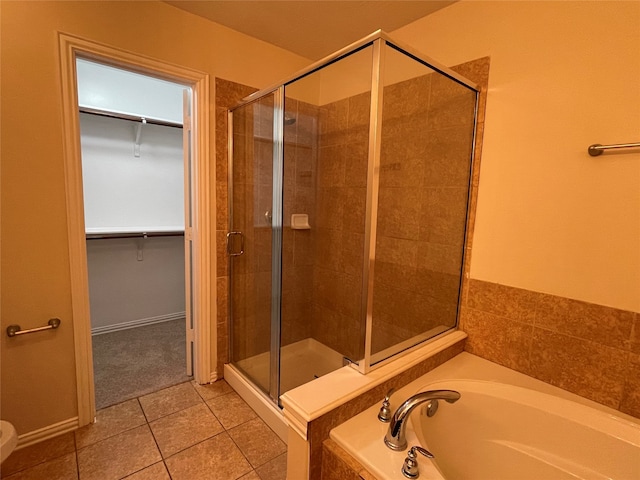 bathroom with shower with separate bathtub and tile patterned floors