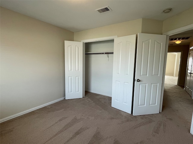 unfurnished bedroom featuring carpet and a closet