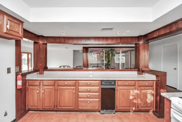 kitchen with kitchen peninsula and light tile patterned floors