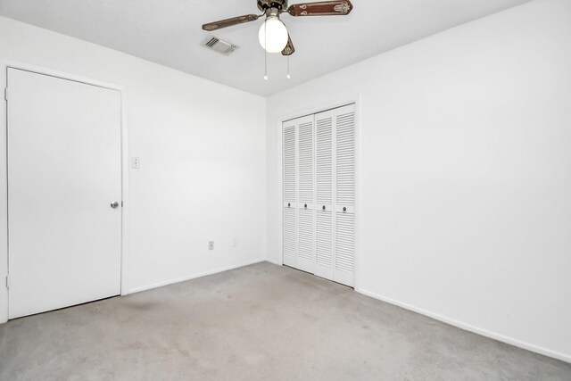 unfurnished bedroom featuring light carpet and ceiling fan