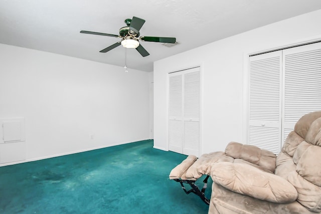 sitting room featuring carpet and ceiling fan