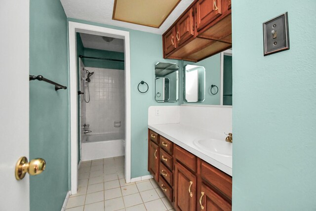 bathroom featuring tiled shower / bath combo, vanity, and tile patterned flooring