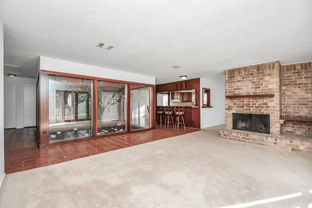 unfurnished living room featuring carpet and a fireplace