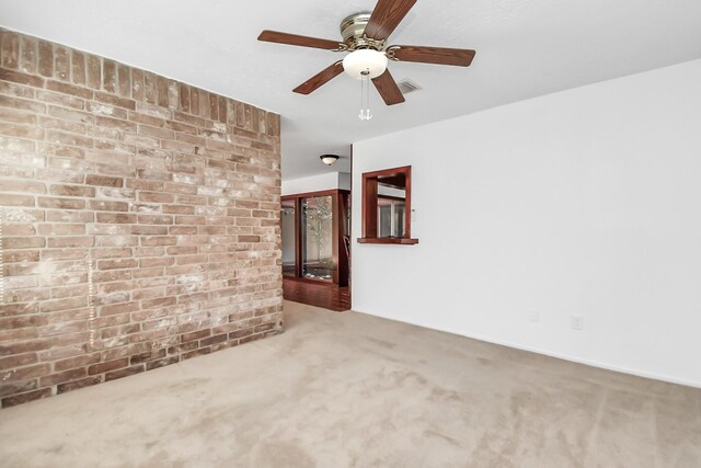 unfurnished living room with carpet floors and ceiling fan