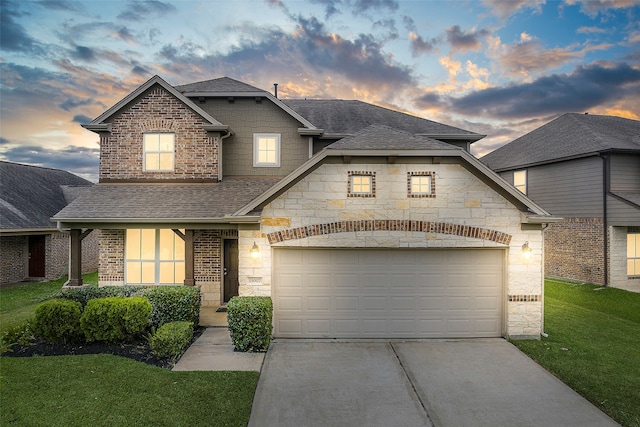 view of front of house featuring a lawn and a garage