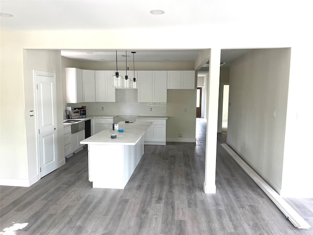 kitchen featuring pendant lighting, white cabinets, light hardwood / wood-style flooring, and a kitchen island