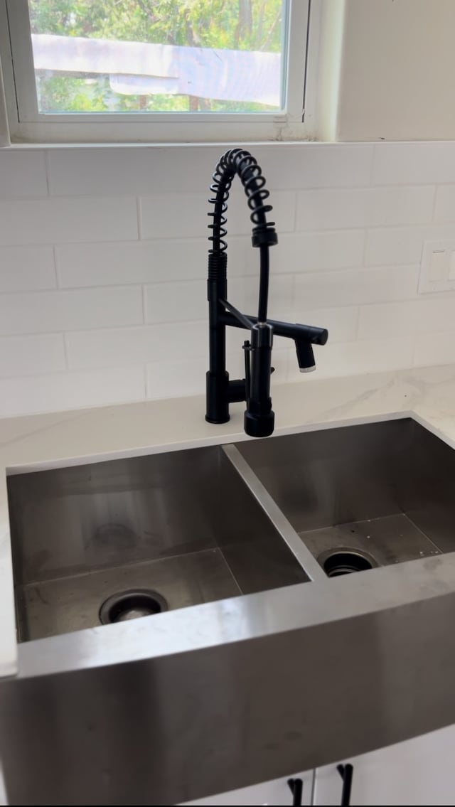 interior details with backsplash and sink