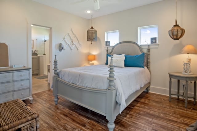 bedroom with connected bathroom, ceiling fan, and dark wood-type flooring