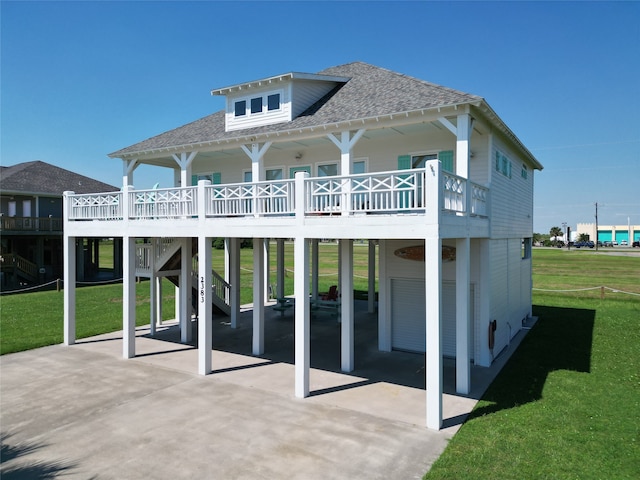 back of house with a lawn and a deck