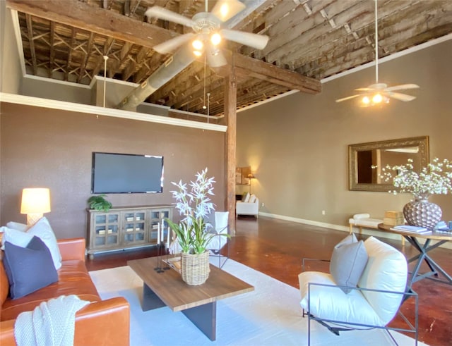 living room with a towering ceiling and ceiling fan