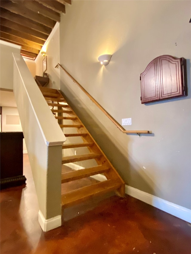 staircase with concrete floors