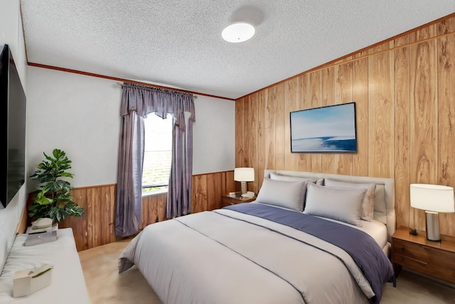 bedroom featuring light carpet, wooden walls, and a textured ceiling