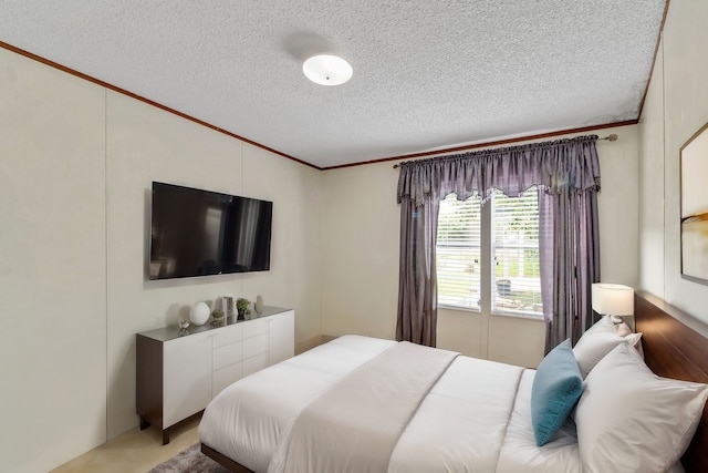 bedroom with a textured ceiling and ornamental molding