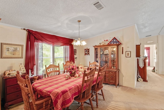 carpeted dining space with an inviting chandelier, a textured ceiling, and crown molding