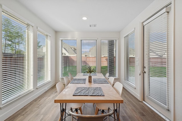 dining space with wood-type flooring and plenty of natural light