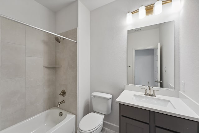 full bathroom featuring tiled shower / bath, vanity, and toilet