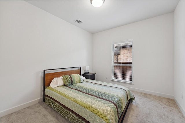 bedroom featuring light carpet