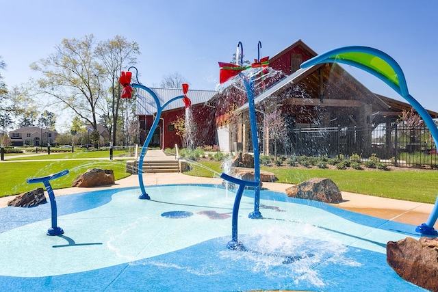 view of pool featuring a lawn