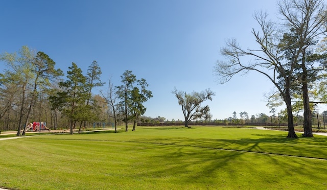 surrounding community featuring a playground and a yard