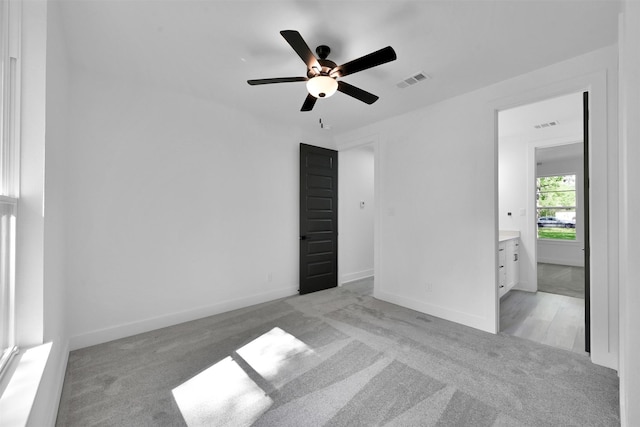 unfurnished room with ceiling fan and light colored carpet