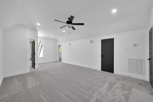 unfurnished living room featuring ceiling fan, light colored carpet, and lofted ceiling