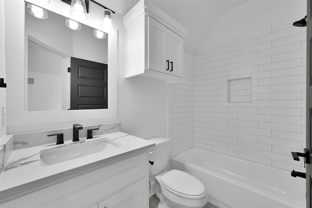 full bathroom with vanity, tiled shower / bath combo, vaulted ceiling, and toilet