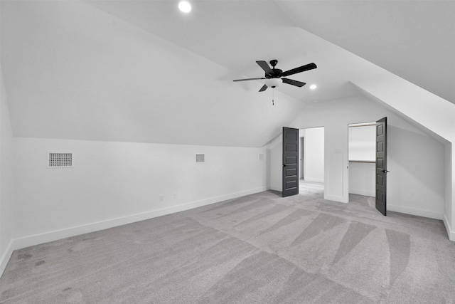 bonus room with ceiling fan, light carpet, and vaulted ceiling