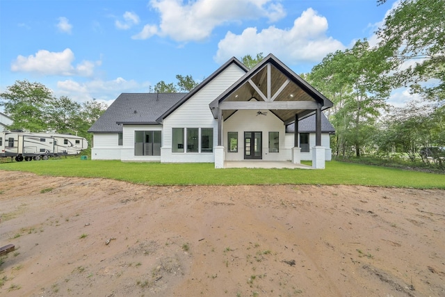 rear view of house featuring a lawn, a patio area, ceiling fan, and french doors