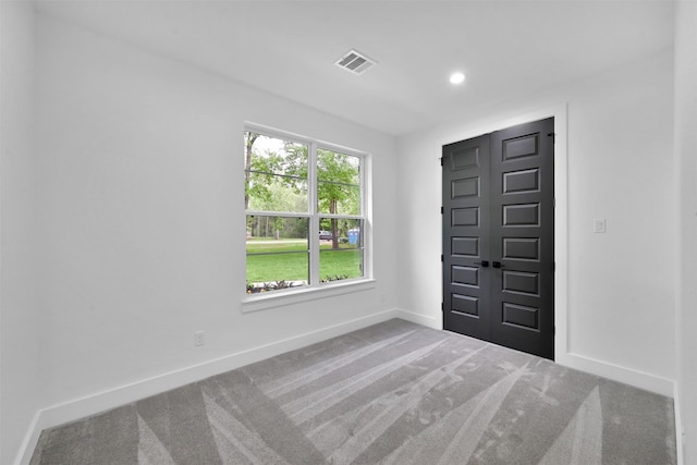 view of carpeted foyer