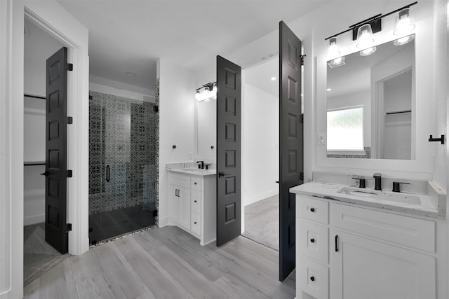 bathroom featuring vanity, wood-type flooring, and an enclosed shower