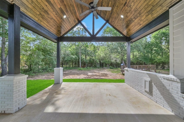 view of patio / terrace with ceiling fan and an outdoor bar