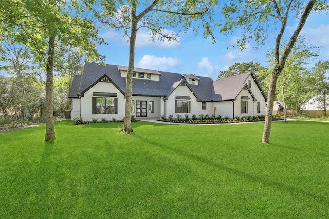 view of front of house with a front yard and french doors