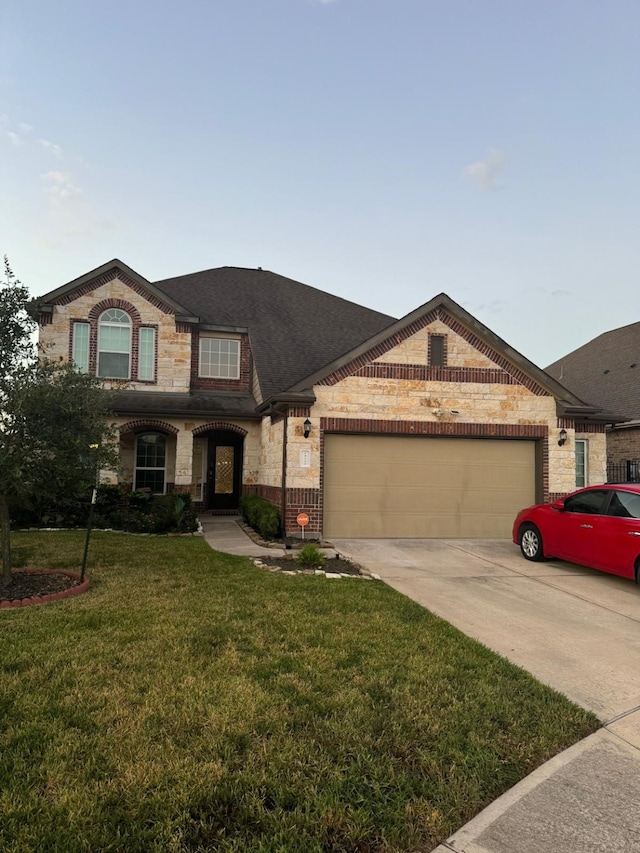 view of front of home featuring a front yard and a garage