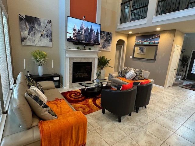 living room featuring light tile patterned floors and a towering ceiling