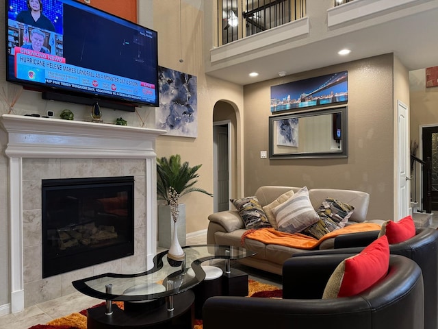 living room featuring light tile patterned floors and a tiled fireplace