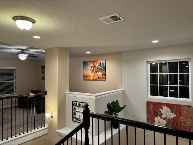 hallway featuring a textured ceiling