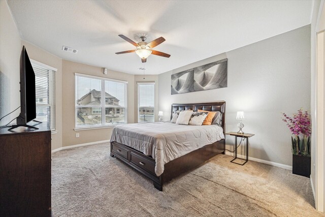 bedroom featuring light carpet and ceiling fan