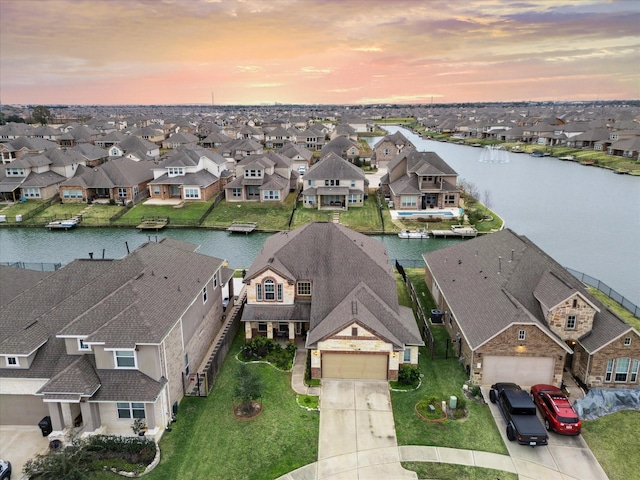 aerial view at dusk with a water view